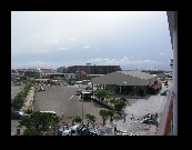 Next stop: Aruba. Looking down at the Oranjestad terminal building at right and the walkway to the bus terminal and main street.